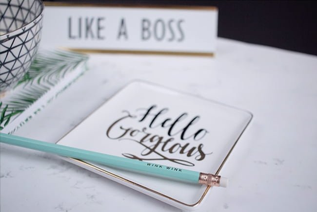 A notebook with the words “Hello gorgeous” written in cursive on a white background. The image illustrates the concept of spring affirmations, which are positive statements that help you embrace a new season and transform your life.